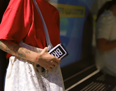 Flicka med en Brick powerbank i handen